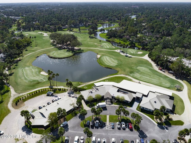 aerial overview of property's location with a golf club, a nearby body of water, and a heavily wooded area