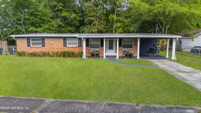 3165 Victoria Park Rd, Jacksonville, FL 32216 - ranch-style home with brick siding, a front lawn, and concrete driveway