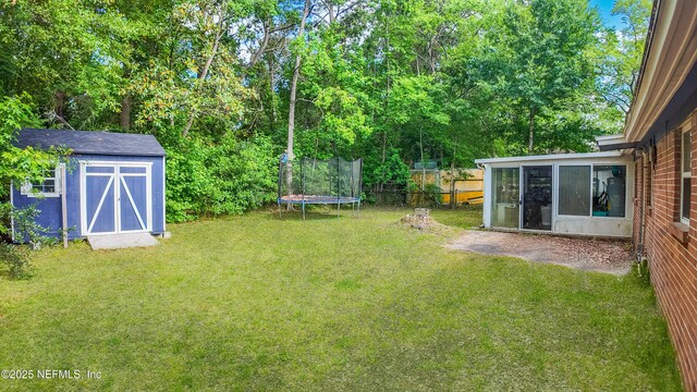 3165 Victoria Park Rd, Jacksonville, FL 32216 - view of yard with a sunroom, an outbuilding, a trampoline, and a storage shed