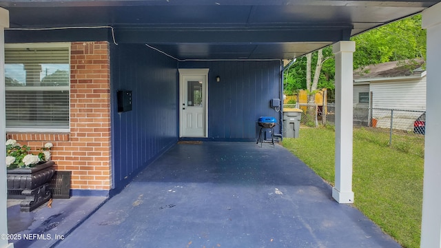 3165 Victoria Park Rd, Jacksonville, FL 32216 - property entrance featuring brick siding, a lawn, fence, and an attached carport