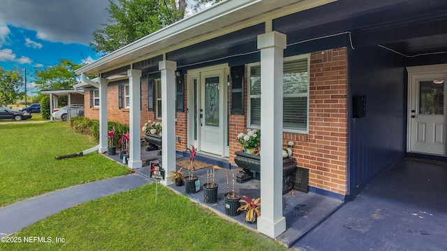 3165 Victoria Park Rd, Jacksonville, FL 32216 - property entrance with covered porch, brick siding, and a yard