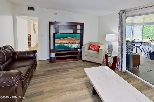 3165 Victoria Park Rd, Jacksonville, FL 32216 - living area featuring visible vents, baseboards, and wood finished floors