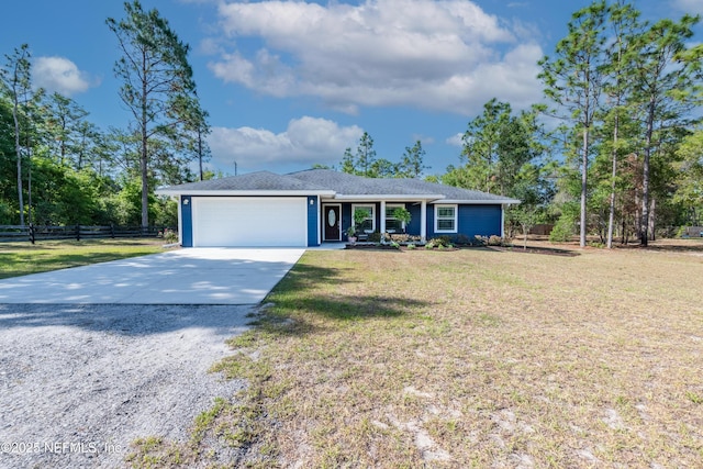 ranch-style home with an attached garage, a front lawn, fence, and concrete driveway