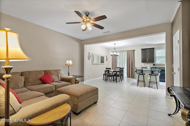 229 Adelanto Ave, Saint Augustine, FL 32092 - living area with ceiling fan, light tile patterned flooring, baseboards, and a chandelier