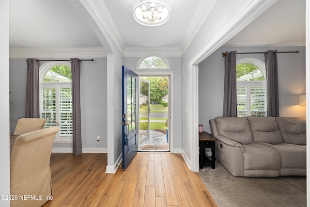 14526 Starbuck Springs Way, Jacksonville, FL 32258 - entryway with a chandelier, light wood-type flooring, crown molding, and plenty of natural light