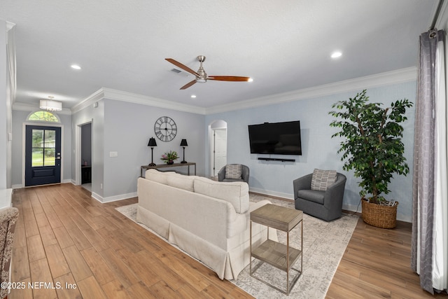 14526 Starbuck Springs Way, Jacksonville, FL 32258 - living room featuring light wood-style flooring, arched walkways, a ceiling fan, recessed lighting, and ornamental molding