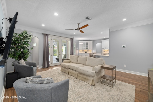 14526 Starbuck Springs Way, Jacksonville, FL 32258 - living area featuring crown molding, a ceiling fan, wood finished floors, recessed lighting, and french doors