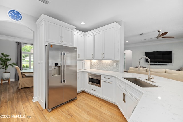 14526 Starbuck Springs Way, Jacksonville, FL 32258 - kitchen featuring stainless steel appliances, arched walkways, ceiling fan, ornamental molding, and open floor plan