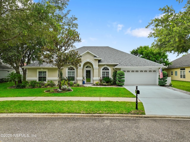 14526 Starbuck Springs Way, Jacksonville, FL 32258 - view of front of house featuring an attached garage, a front lawn, driveway, and stucco siding