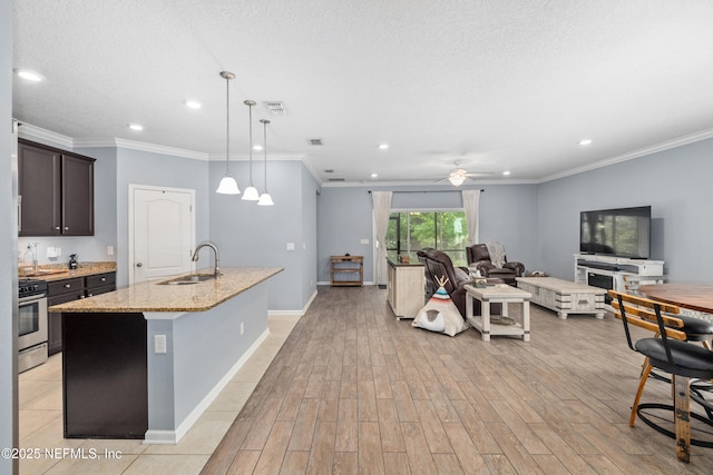 221 Saint Kitts Loop, Saint Augustine, FL 32092 - kitchen with stainless steel range oven, recessed lighting, dark brown cabinets, open floor plan, and light wood-type flooring