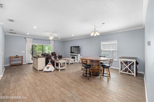 221 Saint Kitts Loop, Saint Augustine, FL 32092 - dining room featuring ornamental molding, wood finished floors, ceiling fan, a chandelier, and a textured ceiling