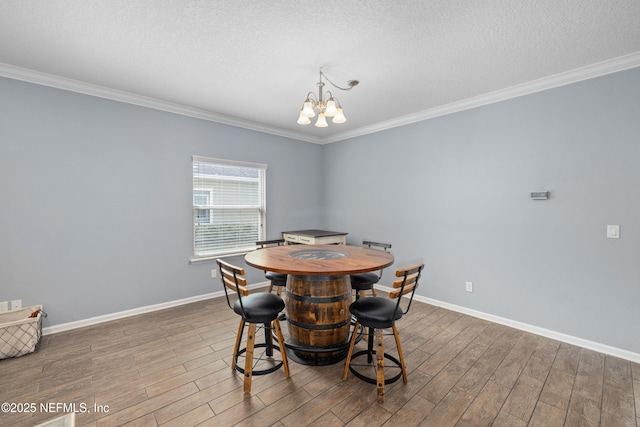 221 Saint Kitts Loop, Saint Augustine, FL 32092 - dining room featuring crown molding, dark wood-style flooring, a chandelier, and a textured ceiling