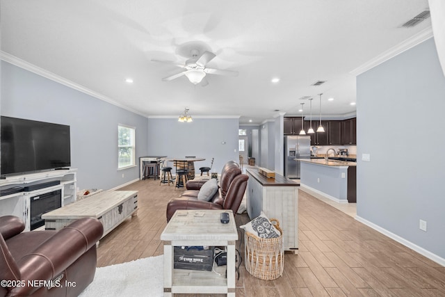 221 Saint Kitts Loop, Saint Augustine, FL 32092 - living area with crown molding, light wood-style floors, a ceiling fan, and recessed lighting