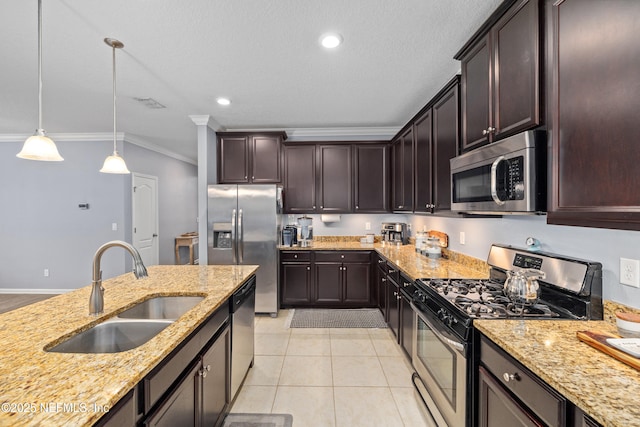 221 Saint Kitts Loop, Saint Augustine, FL 32092 - kitchen featuring stainless steel appliances, ornamental molding, light stone countertops, dark brown cabinetry, and hanging light fixtures