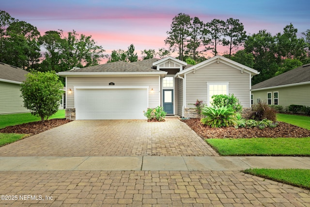 221 Saint Kitts Loop, Saint Augustine, FL 32092 - ranch-style house with decorative driveway, an attached garage, and stone siding