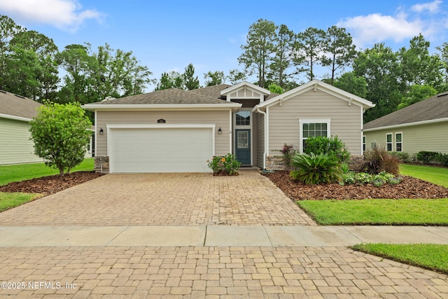 221 Saint Kitts Loop, Saint Augustine, FL 32092 - ranch-style house featuring decorative driveway, stone siding, and a garage