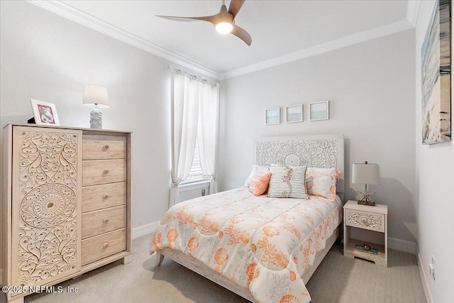 carpeted bedroom with baseboards, ornamental molding, and ceiling fan