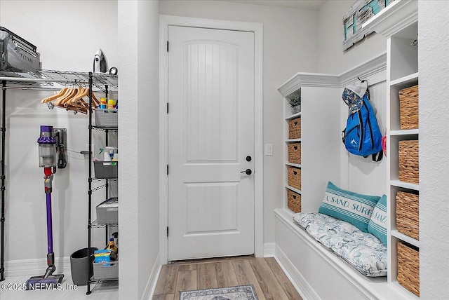 mudroom with baseboards and wood finished floors