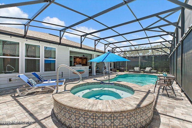 view of swimming pool featuring glass enclosure, a pool with connected hot tub, and a patio area