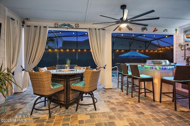 dining area with ceiling fan and brick floor