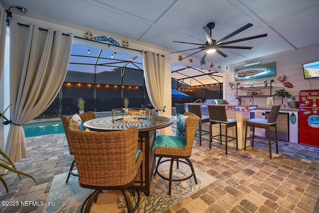 interior space featuring ceiling fan, outdoor wet bar, a swimming pool, and area for grilling
