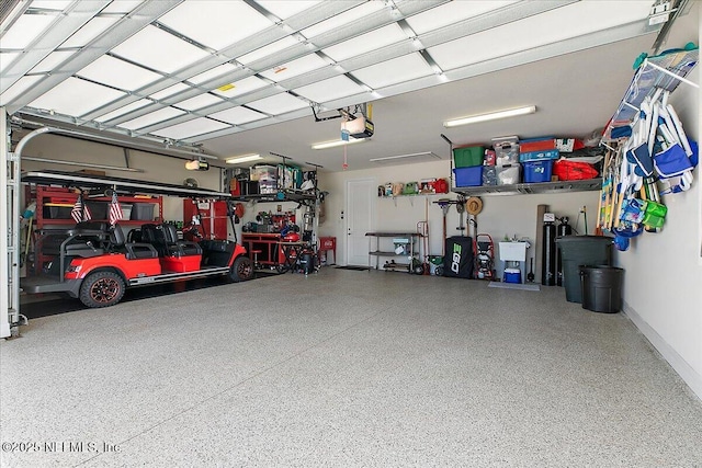 garage with baseboards and a garage door opener