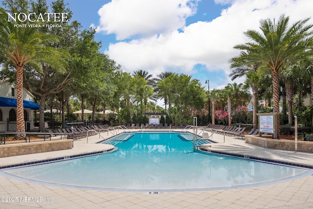 community pool featuring a patio area