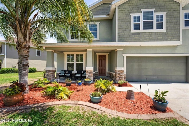 341 Aspen Leaf Dr, Jacksonville, FL 32081 - craftsman-style home with covered porch, concrete driveway, stucco siding, a garage, and stone siding