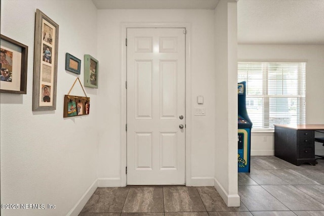 341 Aspen Leaf Dr, Jacksonville, FL 32081 - entryway with baseboards and tile patterned flooring
