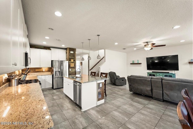 341 Aspen Leaf Dr, Jacksonville, FL 32081 - kitchen with appliances with stainless steel finishes, open floor plan, a ceiling fan, a sink, and recessed lighting