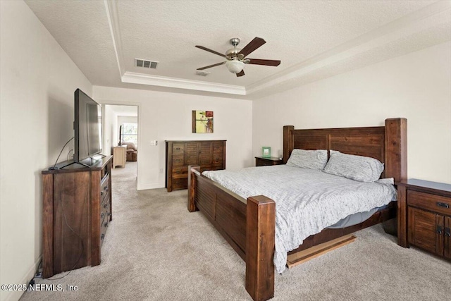 341 Aspen Leaf Dr, Jacksonville, FL 32081 - bedroom with light colored carpet, a tray ceiling, a textured ceiling, and a ceiling fan