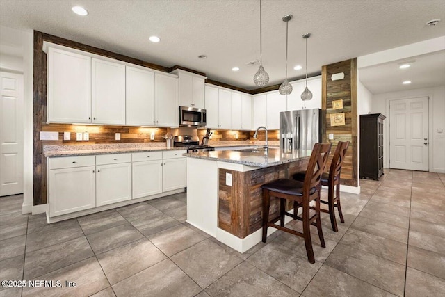 341 Aspen Leaf Dr, Jacksonville, FL 32081 - kitchen with appliances with stainless steel finishes, a sink, tasteful backsplash, light stone counters, and recessed lighting