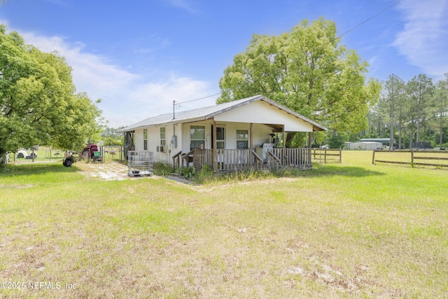 37885 Kings Ferry Rd, Hilliard, FL 32046 - view of front facade featuring covered porch, fence, and a front yard
