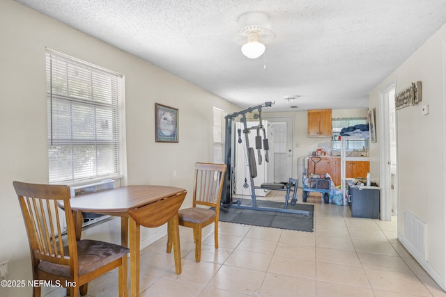 37885 Kings Ferry Rd, Hilliard, FL 32046 - dining space with a textured ceiling, light tile patterned floors, plenty of natural light, and visible vents