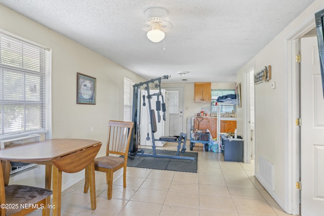 37885 Kings Ferry Rd, Hilliard, FL 32046 - workout room with light tile patterned floors, visible vents, and a textured ceiling