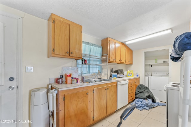 37885 Kings Ferry Rd, Hilliard, FL 32046 - kitchen featuring white appliances, a textured ceiling, washer and dryer, light countertops, and light tile patterned floors