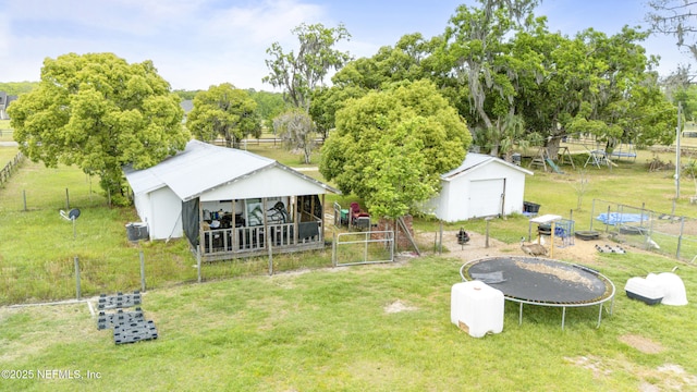 37885 Kings Ferry Rd, Hilliard, FL 32046 - exterior space with an outdoor structure, a trampoline, fence, and a lawn