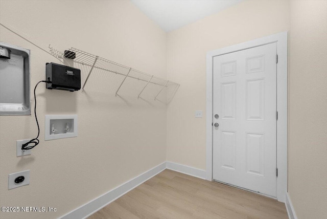 clothes washing area with laundry area, electric dryer hookup, washer hookup, and light wood finished floors