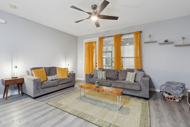 625 Oakleaf Plantation Pkwy Unit 1115, Orange Park, FL 32065 - living room with baseboards, a ceiling fan, and wood finished floors