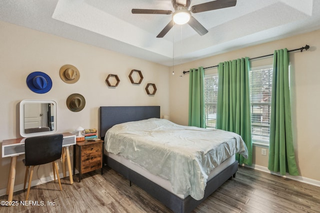 625 Oakleaf Plantation Pkwy Unit 1115, Orange Park, FL 32065 - bedroom featuring a raised ceiling, baseboards, a ceiling fan, and wood finished floors