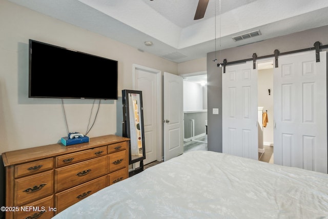 625 Oakleaf Plantation Pkwy Unit 1115, Orange Park, FL 32065 - bedroom with a ceiling fan, a barn door, and visible vents
