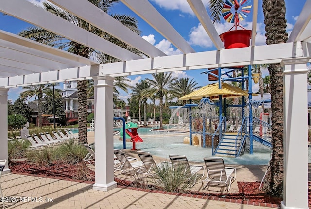 625 Oakleaf Plantation Pkwy Unit 1115, Orange Park, FL 32065 - view of patio / terrace featuring playground community, a community pool, and a pergola