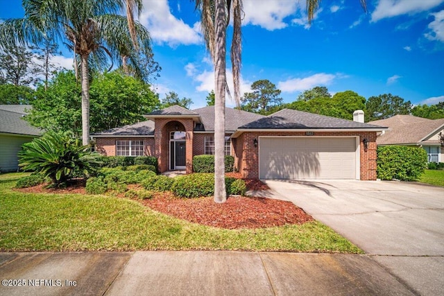 ranch-style home featuring an attached garage, a chimney, a front lawn, brick siding, and driveway