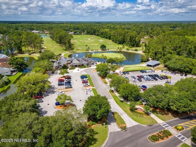 aerial view with a water view and a forest view