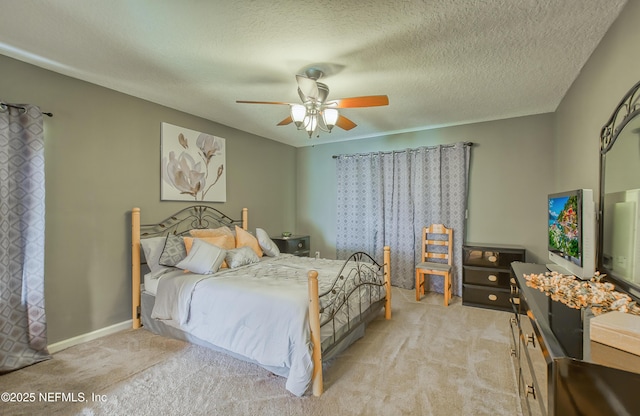 bedroom with a ceiling fan, light carpet, a textured ceiling, and baseboards
