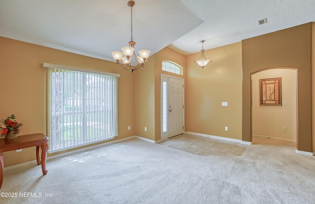 entryway with a chandelier, light carpet, baseboards, and visible vents
