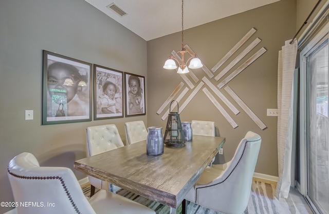 dining room featuring an inviting chandelier, baseboards, and visible vents