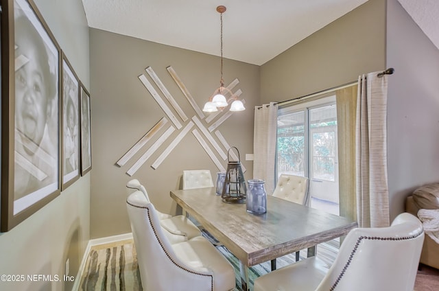 dining area with a notable chandelier and baseboards