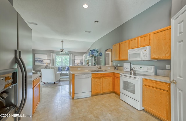 kitchen with a peninsula, a sink, open floor plan, ceiling fan, and white appliances