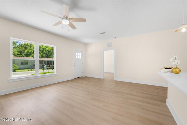 unfurnished living room with baseboards, a ceiling fan, light wood-style flooring, and visible vents